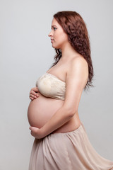 Portrait of a pregnant woman with curly hair