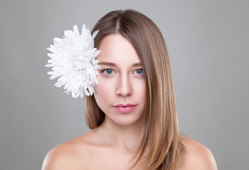 Beautiful brunette woman with a white flower