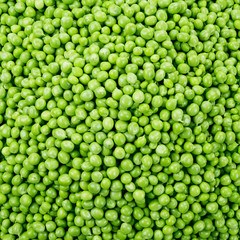Fresh raw peas. Green background.