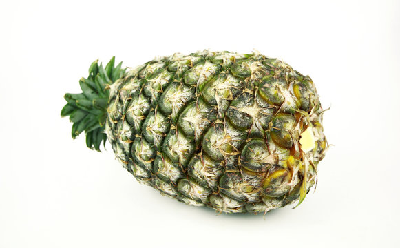 Ripe pineapple with slices isolated on white background