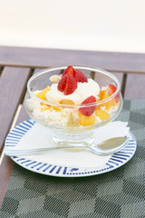 Desert with cottage cheese and fruits on the wooden table
