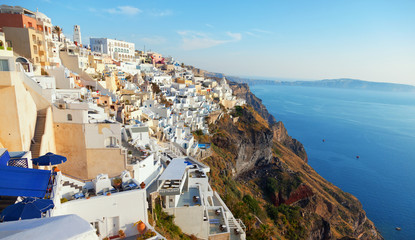 Fototapeta na wymiar Cityscape panorama of Fira town, Santorini in the late afternoon