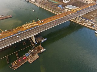 Construction of the bridge across the river. Aerial view.