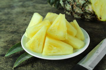 Ripe pineapple with slices isolated on white background