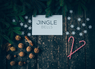 Merry Christmas and Jingle Bells on wood Background - obrazy, fototapety, plakaty