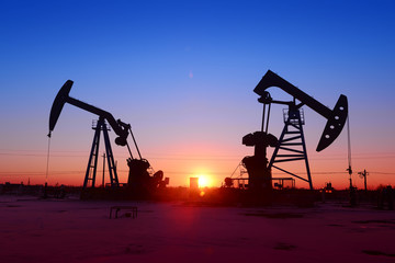 The beam pumping unit is homework, sunset in oil field