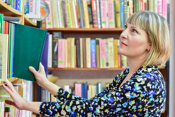 Information age/The girl - librarian looking for a reserved book