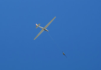 propeller-driven airplane is towing a glider