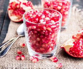 Fresh organic pomegranate seeds in glasses