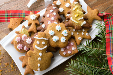 Colorful Christmas gingerbread cookies on wooden background