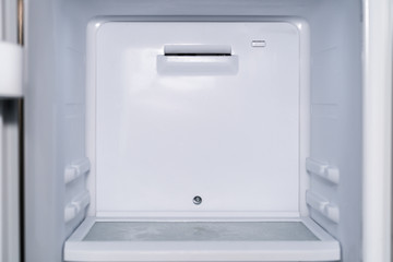 Inside of an empty white fridge