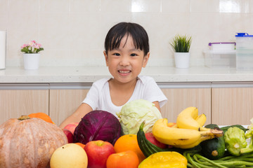 Fototapeta premium Happy Asian Chinese little girl with fruit and vegetable