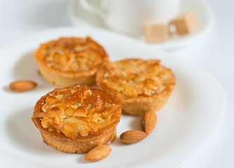 Almond cookies strewed with nut slices glazed caramel  close up