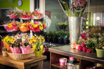 Plant pots and bouquet on table