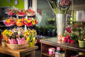 Plant pots and bouquet on table