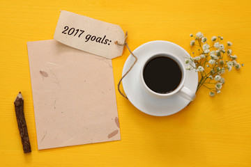 Obraz na płótnie Canvas Top view 2017 goals list with notebook, cup of coffee