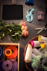 Digital tablet and florist supplies on the wooden table
