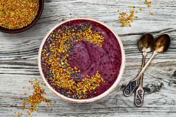 Acai breakfast superfoods smoothies bowl with chia seeds, bee pollen toppings. Immune boosting,...