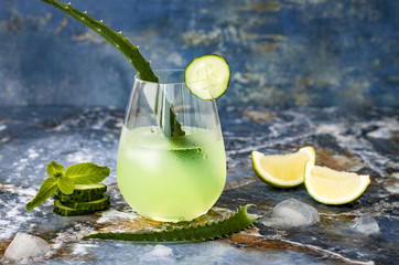 Sparkling cucumber mint gin and tonic fizz with aloe vera on marble table. Copy space. Dragon tail...