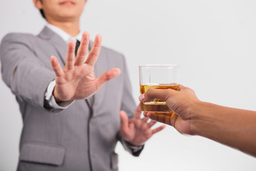 businessman in shirt and tie don't drinking whiskey ;he must driving to home after office hour