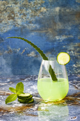 Sparkling cucumber mint gin and tonic fizz with aloe vera on marble table. Copy space. Dragon tail...
