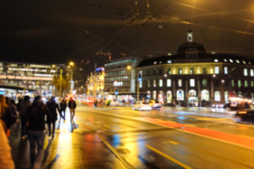 Fototapeta na wymiar Pedestrian on Footpath with Traffic - Night street of lucerne,switzerland - Blurred for background
