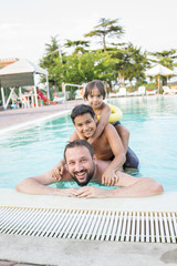 Young boy kid child splashing in swimming pool having fun leisur