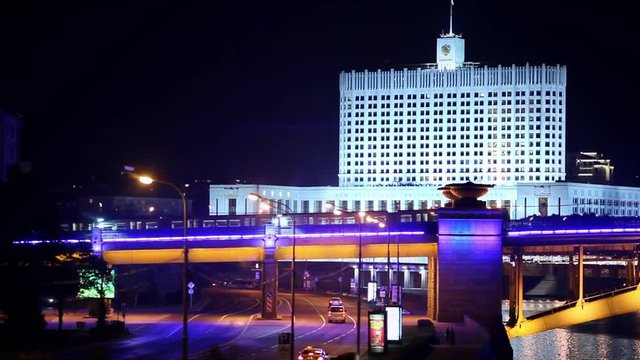 White house at night, motion Metro over the bridge across the river in Moscow