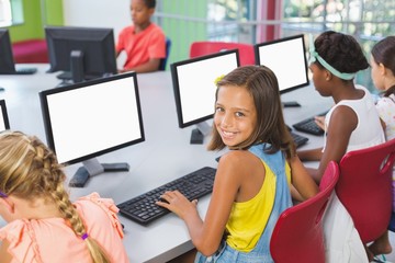 School kids using computer in classroom