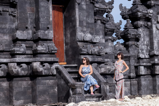 Two caucasian women in sunglasses near the balinese temple. Explore Indonesia, Bali.