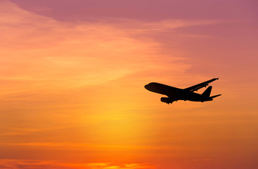Fototapeta premium Sylwetka samolotu lecącego na zachód słońca
