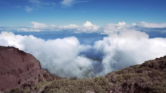 Rising clouds time lapse of the "Roque de los Muchachos" in "La Palma". The background shows the atlantic ocean.