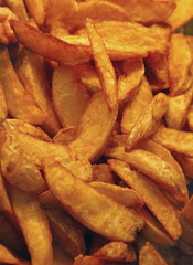 Deep fried or baked potato wedges close up