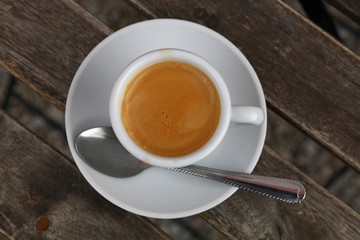 Espresso coffee in white cup close up top view