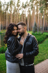 Couple in love - Beginning of a Love Story. A man and woman in evening dress, embrace and kiss while walking