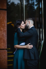 Couple in love - Beginning of a Love Story. A man and woman in evening dress, embrace and kiss while walking