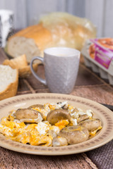 Fried mushrooms with fried eggs on the plate