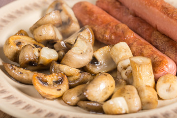 Fried sausages with sliced fried mushrooms