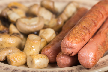 Fried sausages with sliced fried mushrooms