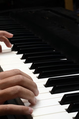 Child hands playing piano