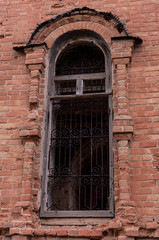 Close-up of window opening  on destroyed  brick wall.