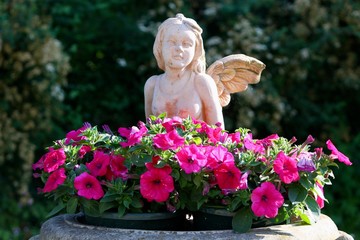 angel sculpture with flowers