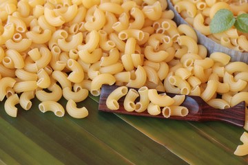 Raw small yellow macaroni pasta for cooking.