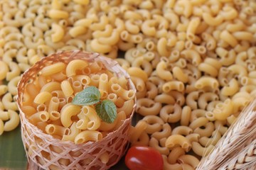 Raw small yellow macaroni pasta for cooking.