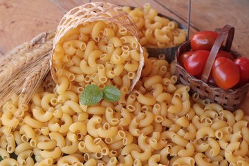 Raw small yellow macaroni pasta for cooking.