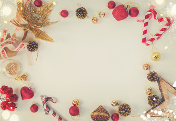 Christmas flat lay styled scene - frame with red and golden decorations, retro toned