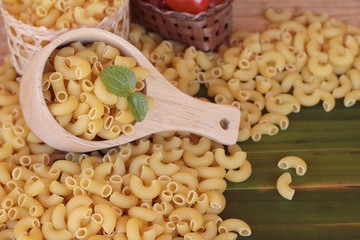 Raw small yellow macaroni pasta for cooking.