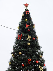 Christmas tree with garland and a star, decorated with toys
