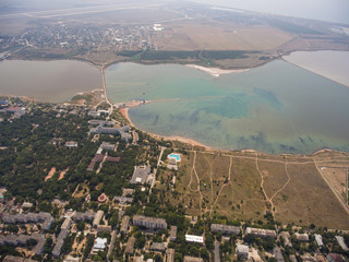 Panorama of the city and different colors lakes.