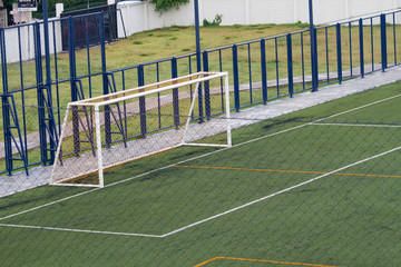 Futsal court in a public outdoor park with artificial turf